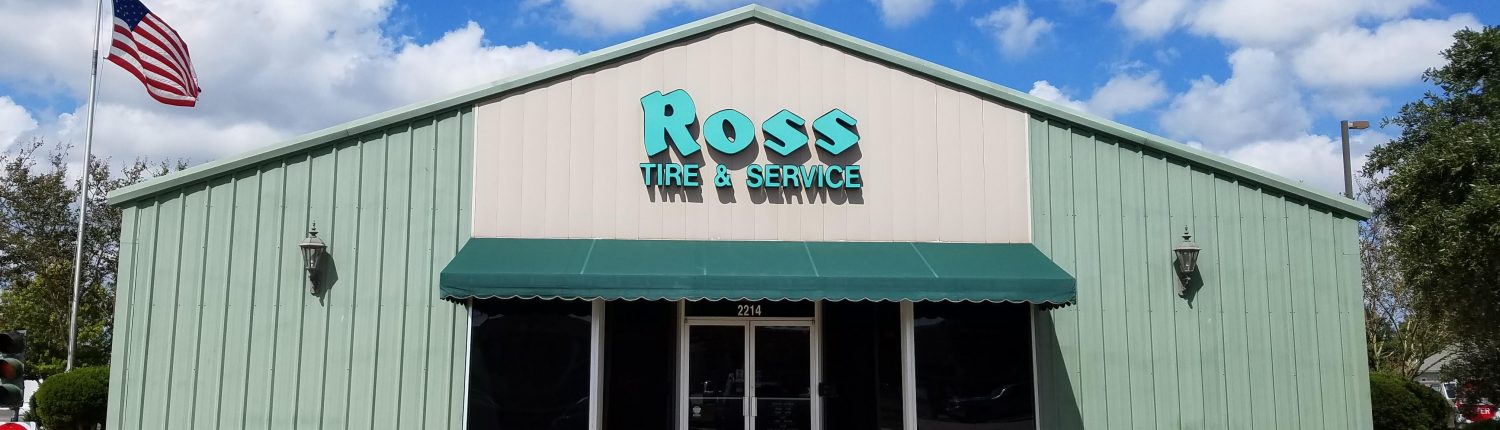 Front of Ross Tire & Service in Lafayette, LA with American flag and front parking area